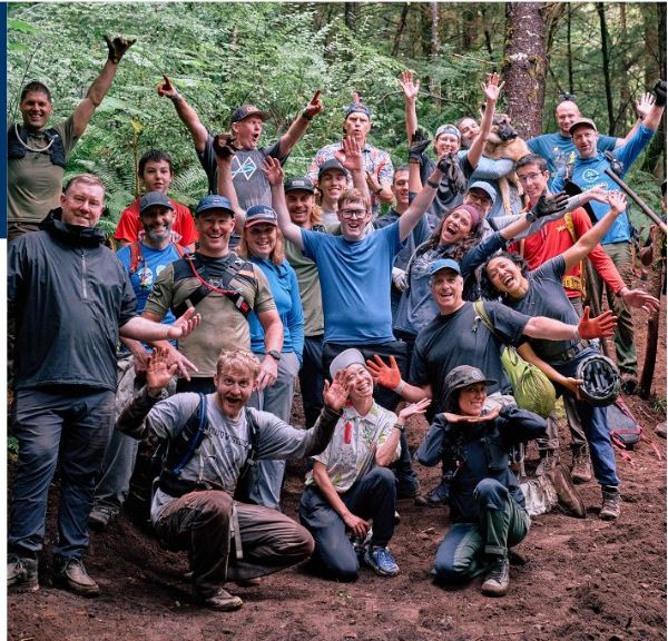 Evergreen trail crew celebrating in the woods